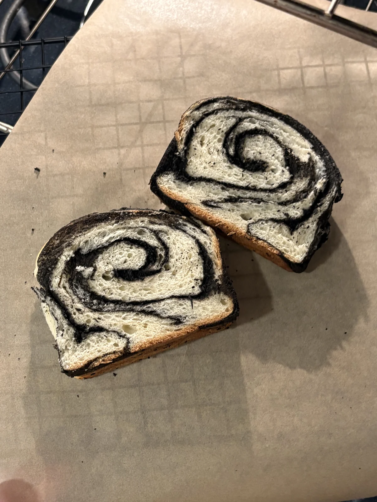 Two slices of black-and-white swirl bread.